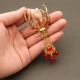 Dangling_Red_Bells_and_Gold_Chain_Detail